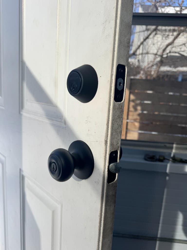 Exterior view of new deadbolt and doorknob installation
